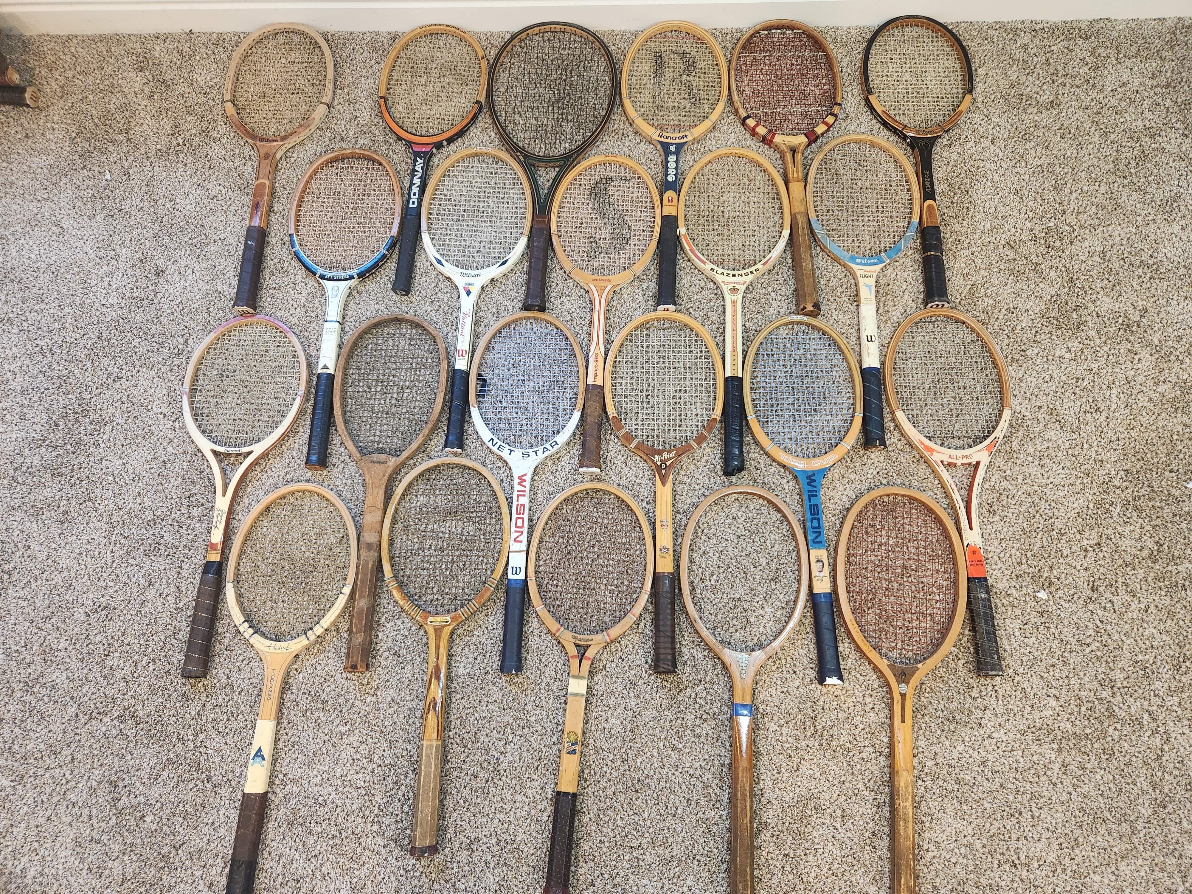 Vintage wood tennis rackets for sale — group inventory shot of 24 pieces