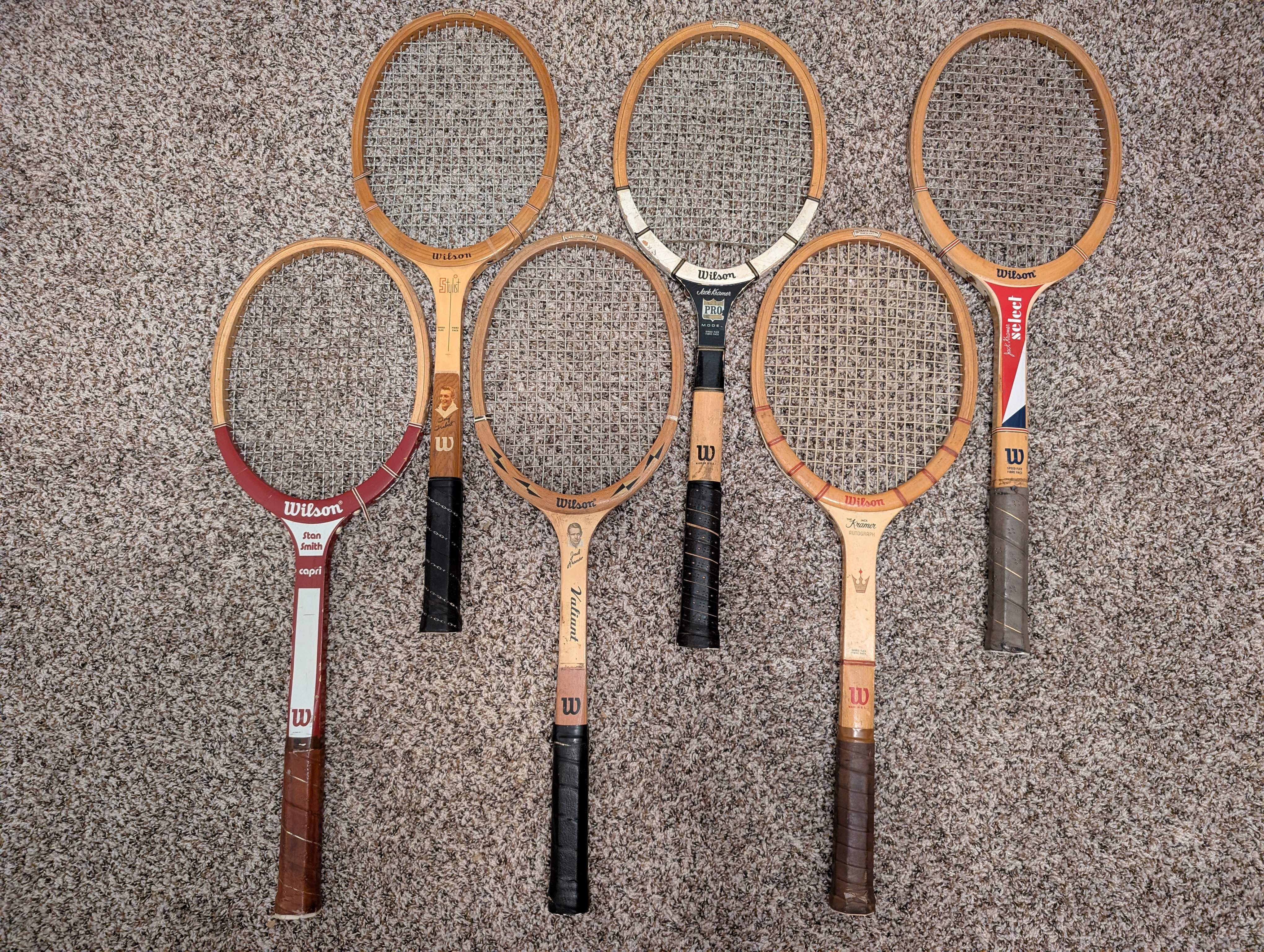 Vintage wood tennis rackets for sale — group inventory shot of Wilson brand rackets