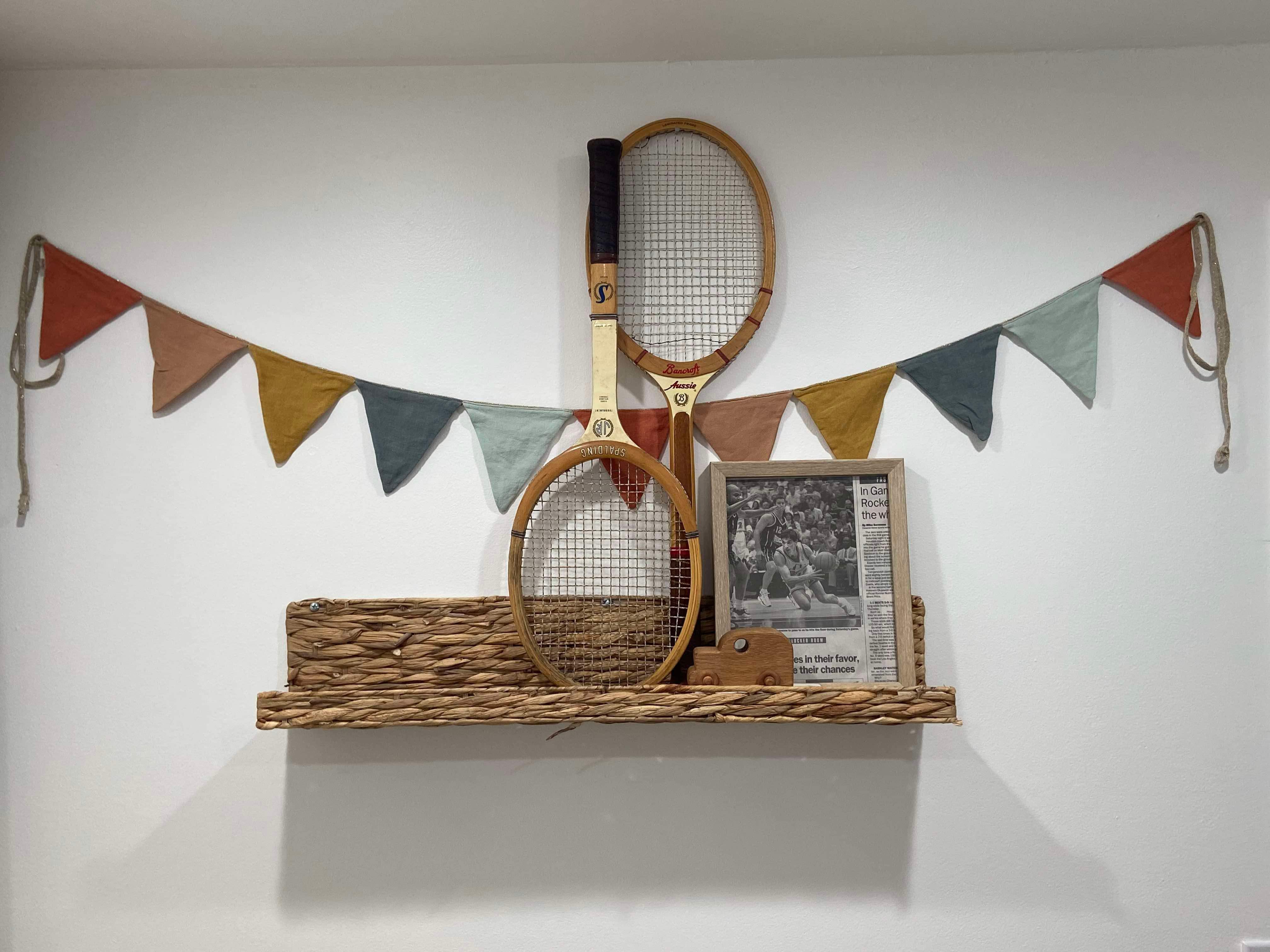 Vintage wood tennis rackets as decorative home decor on shelf